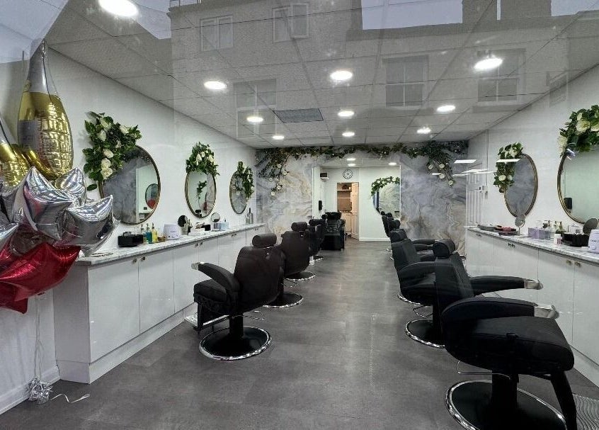 Elegant interior of Olympus Hair, Chester, England, GB with stylish chairs and decorative mirrors.