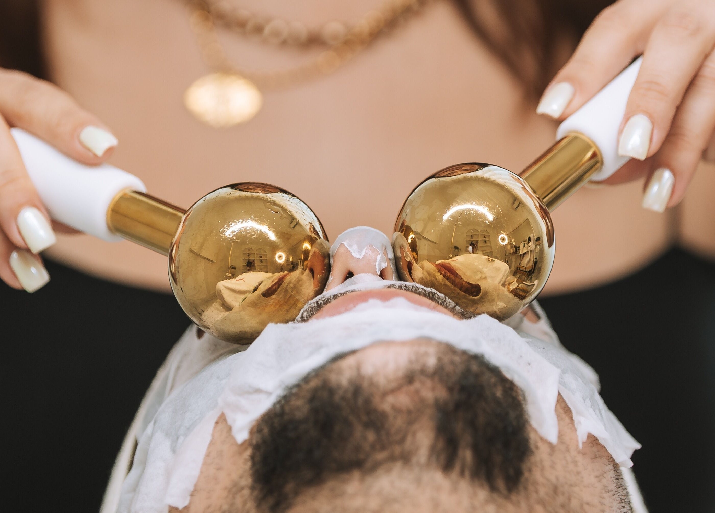 Luxurious facial massage at Olimpo Skin, Santarém, Santarém, PT with golden sculpting tools.