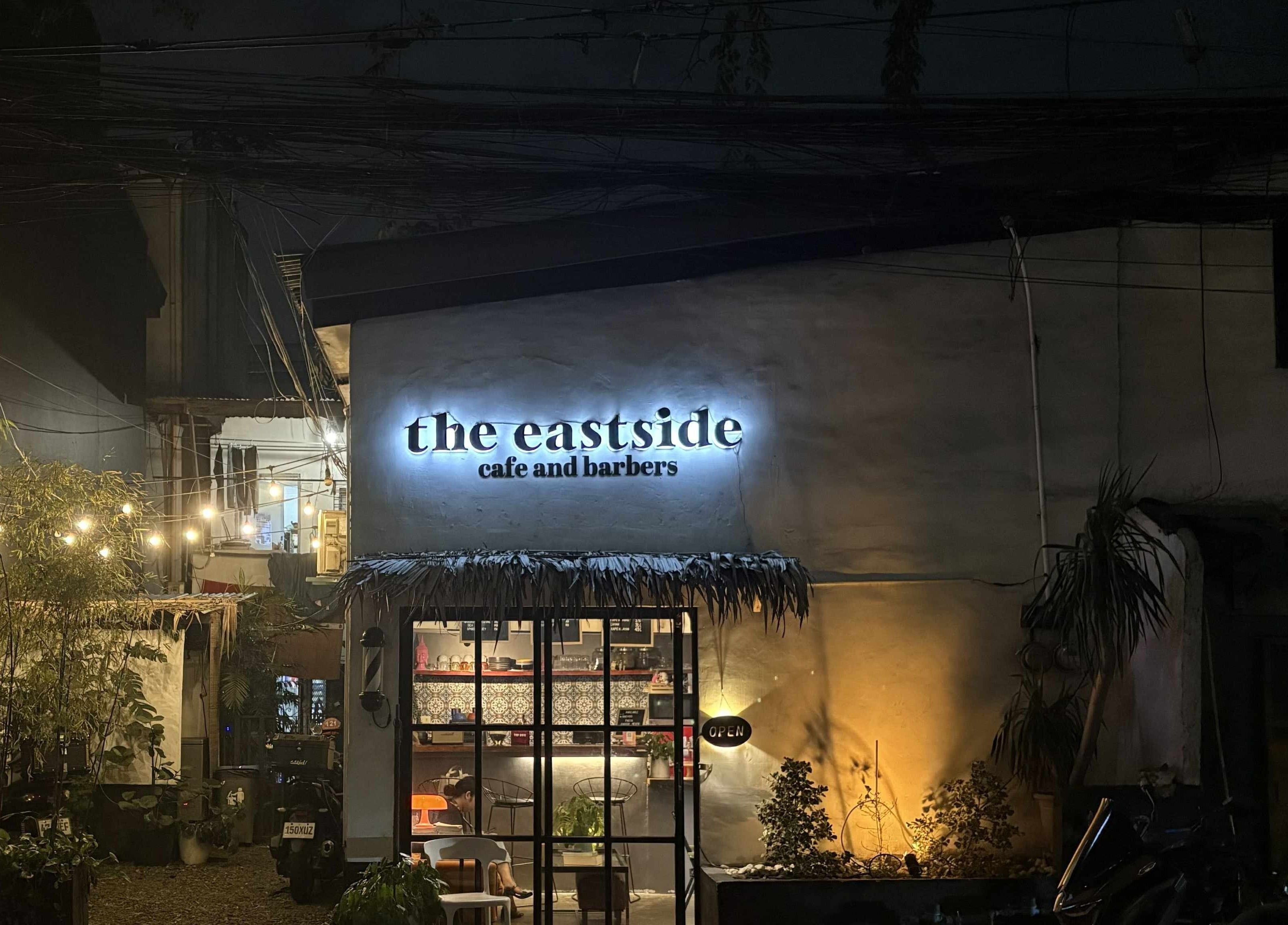 The Eastside Cafe & Barbers warmly lit exterior at night in Marikina City, Metro Manila, PH.