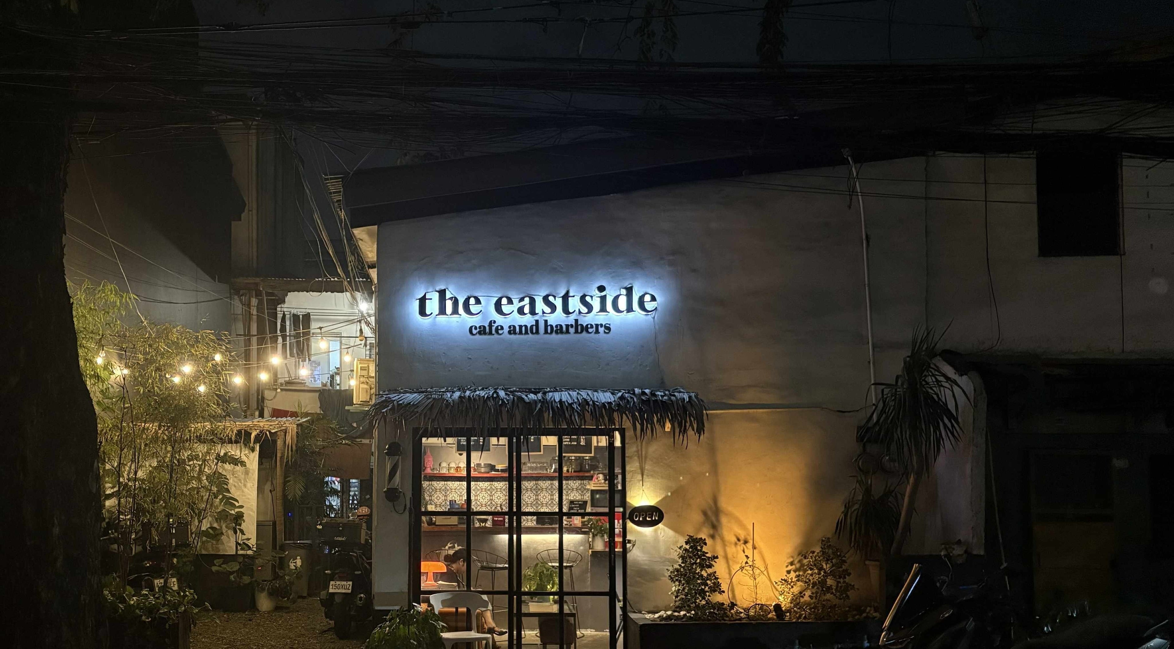 The Eastside Cafe & Barbers warmly lit exterior at night in Marikina City, Metro Manila, PH.