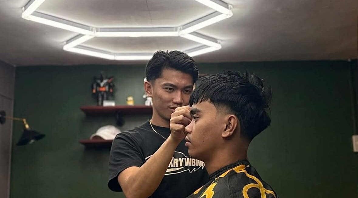 Stylist giving haircut at The Eastside Cafe & Barbers, Marikina City, Metro Manila, PH.