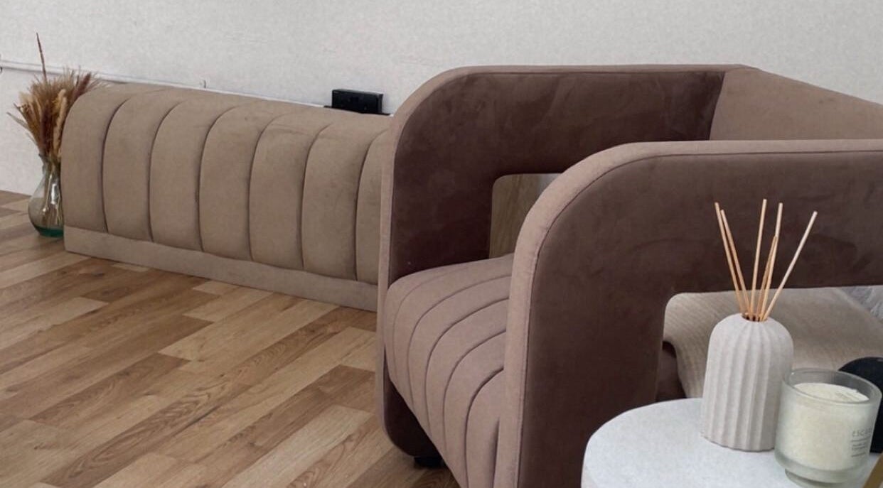 Elegant seating area at Lash & Brow Expert, London, England, GB, featuring modern decor and a calming ambiance.