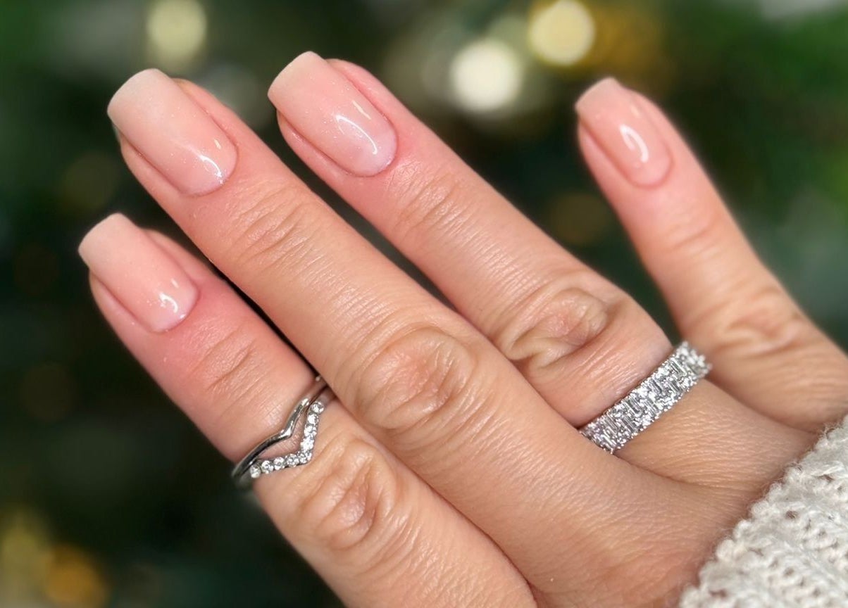 Elegant manicure from Arlène Nails GB featuring natural pink polish with sparkling rings.
