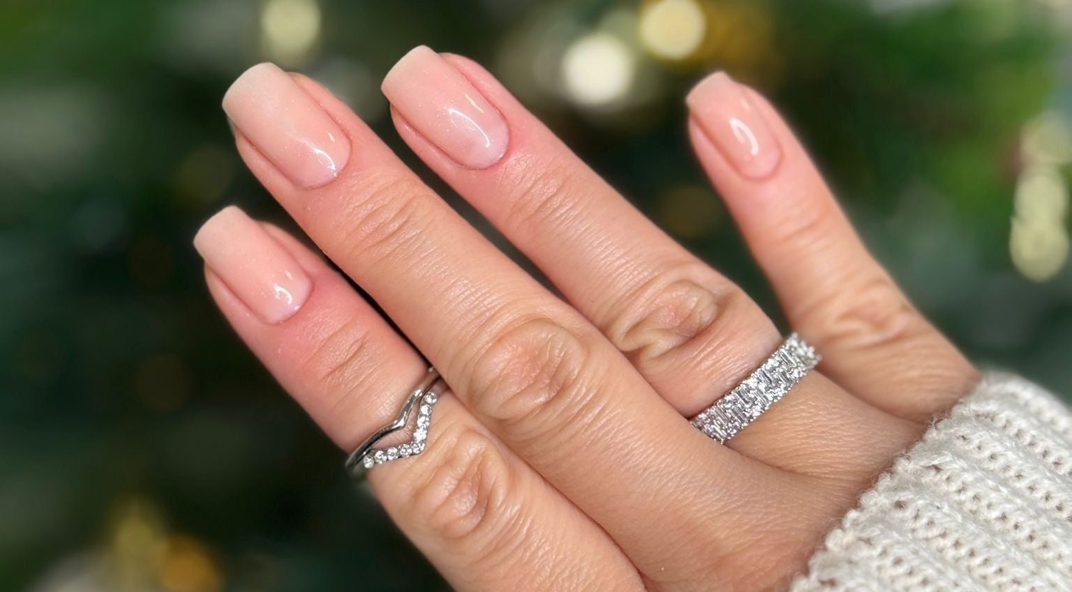Elegant manicure from Arlène Nails GB featuring natural pink polish with sparkling rings.