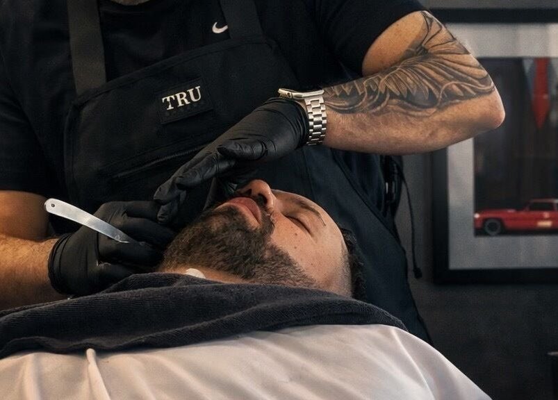 Barber provides a classic shave at Sanctuary Barber Co in Beaverton, Oregon, US.