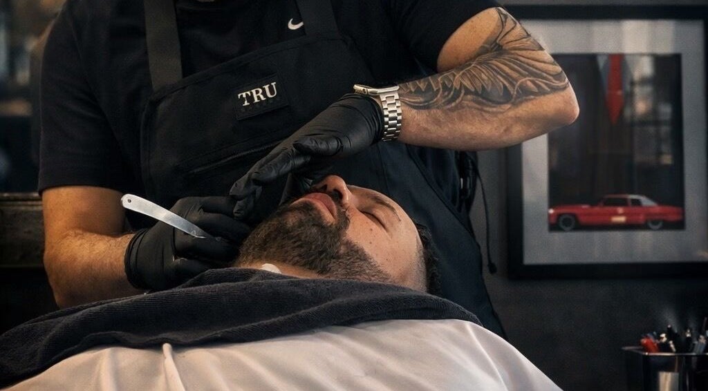 Barber provides a classic shave at Sanctuary Barber Co in Beaverton, Oregon, US.
