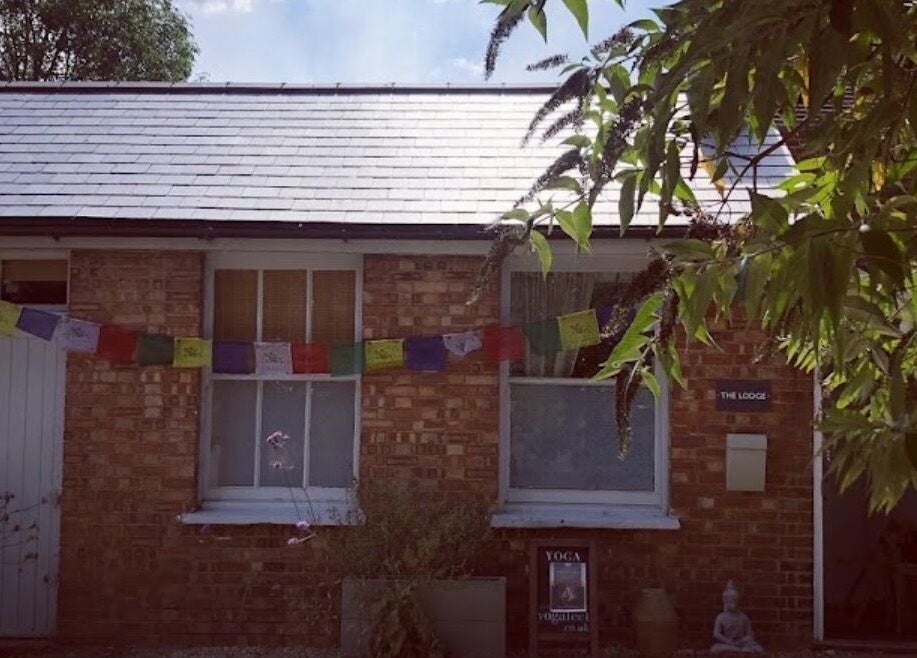 Exterior of Jess Clark Yoga Massage studio in Hitchin, England, GB, featuring serene decor and greenery.