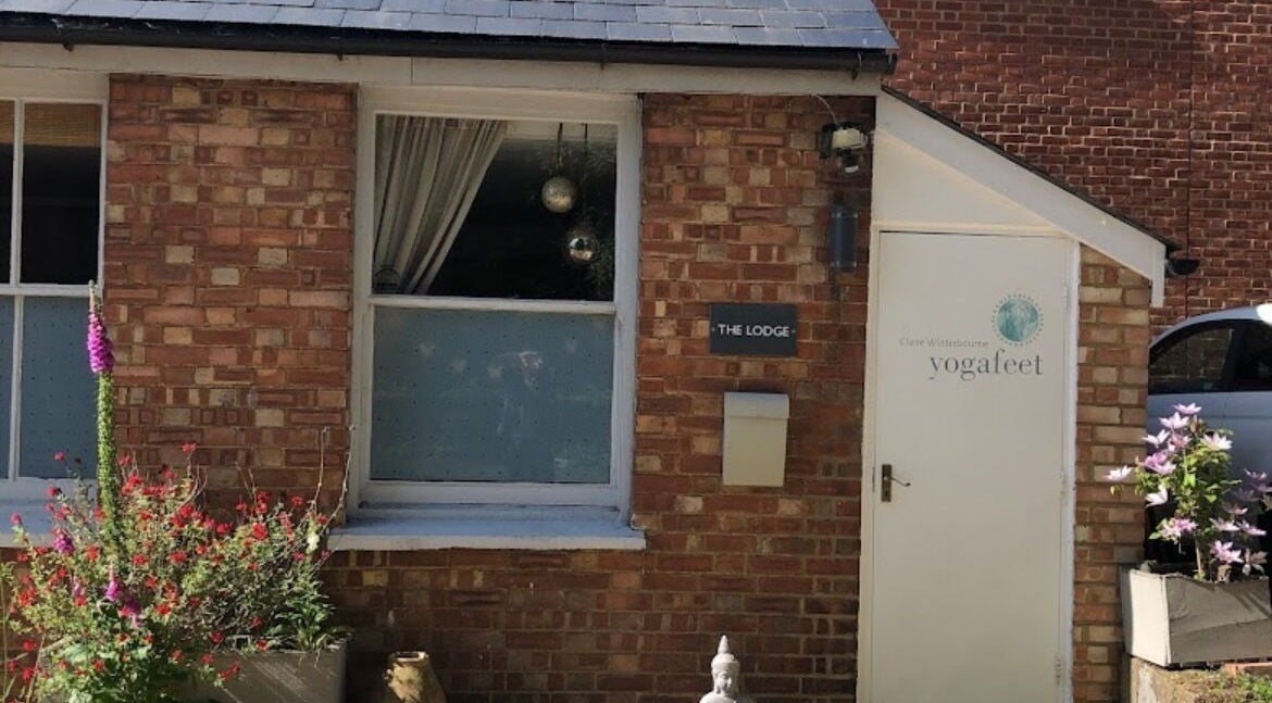 Front view of Jess Clark Yoga Massage venue in Hitchin, England, GB with vibrant flowers and a white entrance.