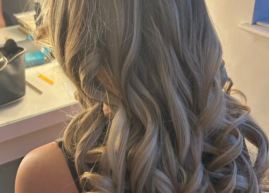 Blonde curls styled at Hairbykatiejb.x in Chalfont Saint Peter, England, GB, reflecting elegance and sophistication.