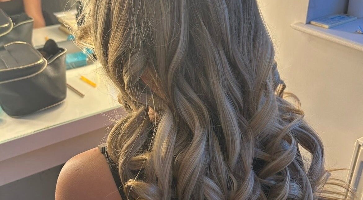 Blonde curls styled at Hairbykatiejb.x in Chalfont Saint Peter, England, GB, reflecting elegance and sophistication.