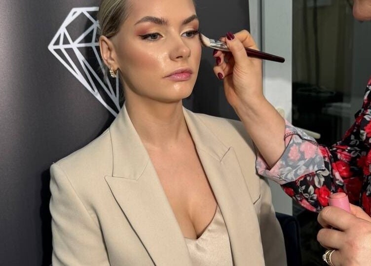 Makeup artist enhancing client's features at Austeya Artistry, Richmond, England, GB with expert precision.