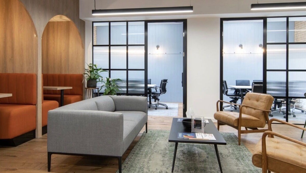 Modern lounge area at Iron Rice Bowl Coaching, Hong Kong, HK, featuring stylish sofas and chairs.