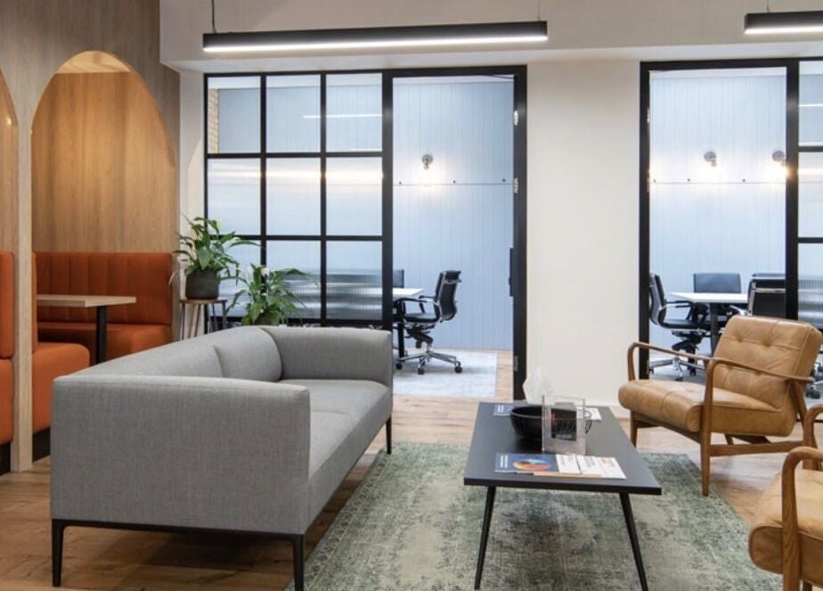 Modern lounge area at Iron Rice Bowl Coaching, Hong Kong, HK, featuring stylish sofas and chairs.