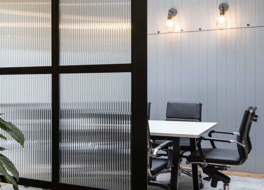 Modern meeting room at Iron Rice Bowl Coaching, Hong Kong, HK featuring sleek chairs and frosted glass.