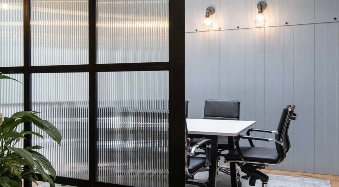 Modern meeting room at Iron Rice Bowl Coaching, Hong Kong, HK featuring sleek chairs and frosted glass.