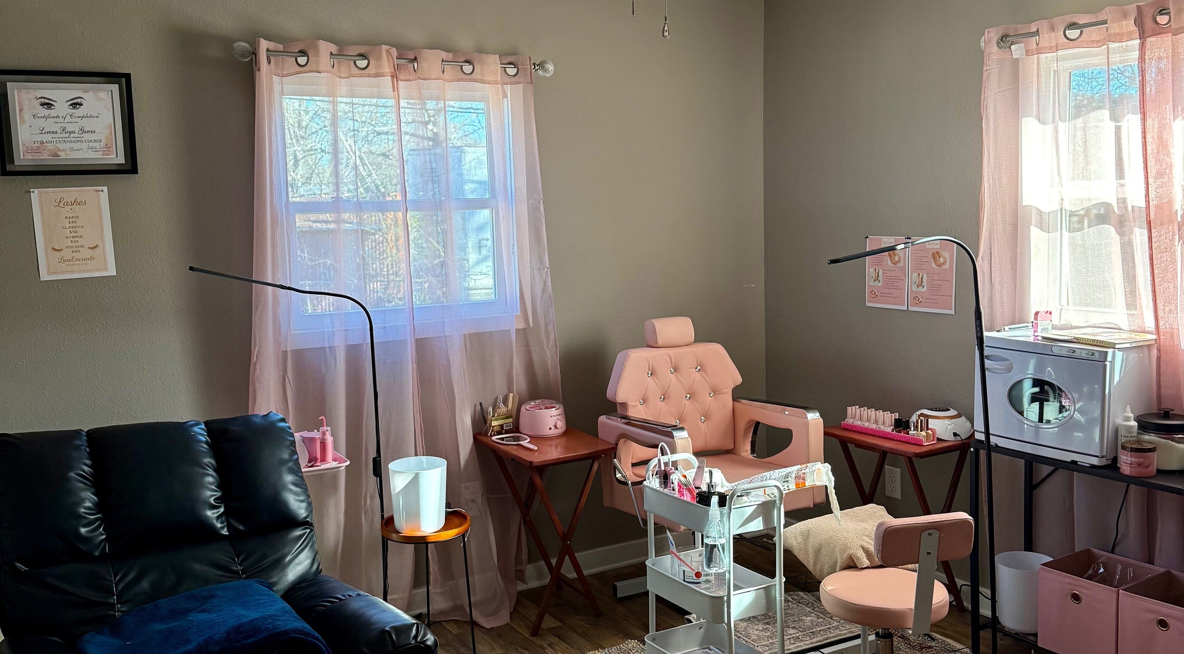 Stylish beauty setup at Luxe Encanto Studio LLC in Gadsden, Alabama, US with pink decor and leather chair.
