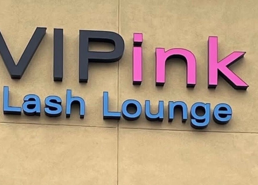 Colorful sign of VIP Lash & Facial in Folsom, California, US, showcasing bold fonts.
