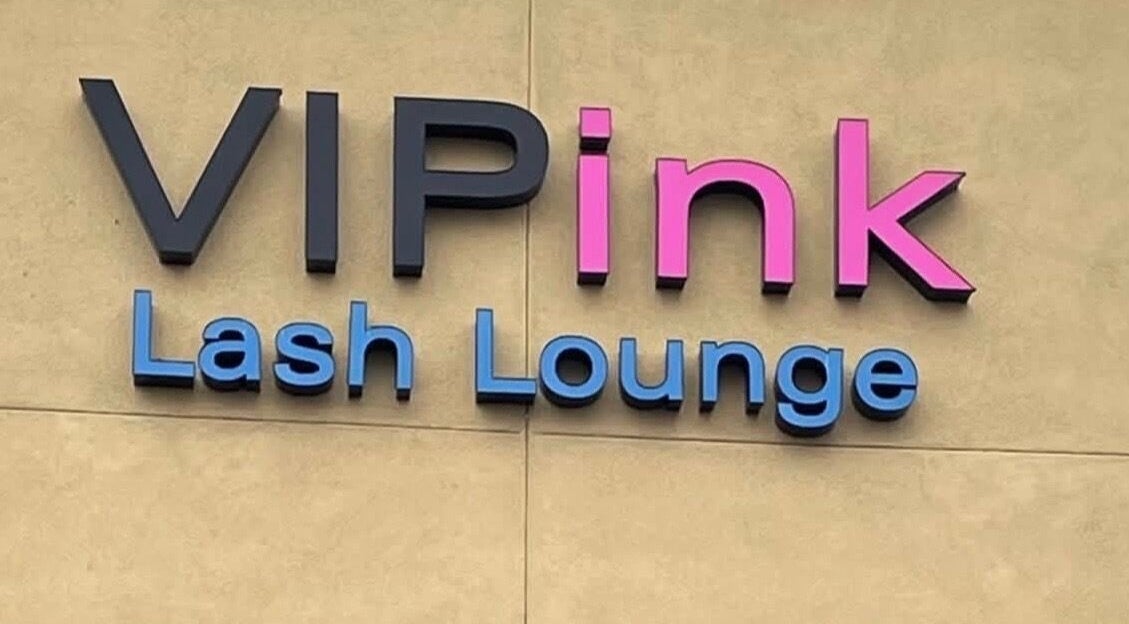 Colorful sign of VIP Lash & Facial in Folsom, California, US, showcasing bold fonts.