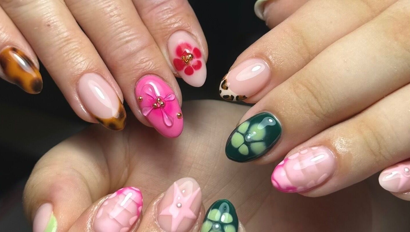Intricate floral nail designs at Bymiaf, Salford, England, GB showcasing vivid colors and detailed art.