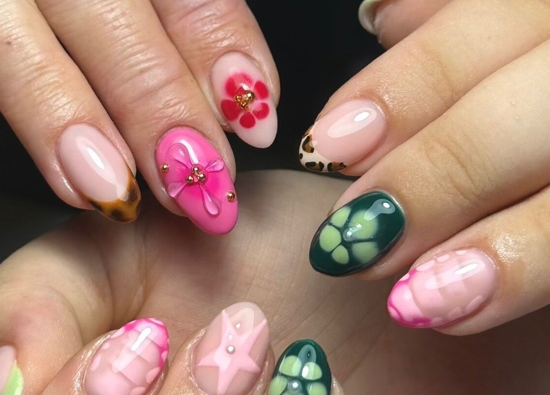 Intricate floral nail designs at Bymiaf, Salford, England, GB showcasing vivid colors and detailed art.