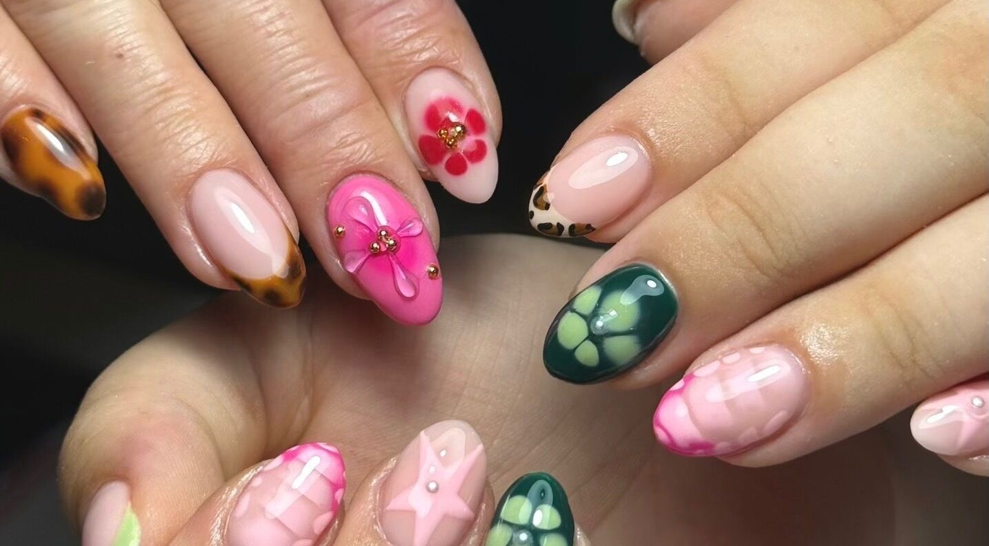 Intricate floral nail designs at Bymiaf, Salford, England, GB showcasing vivid colors and detailed art.