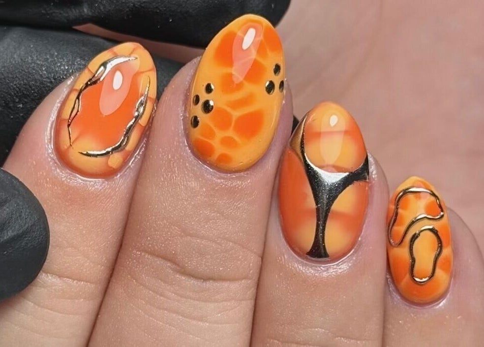Stunning artistic nail design in orange and black at Bymiaf, Salford, England, GB.
