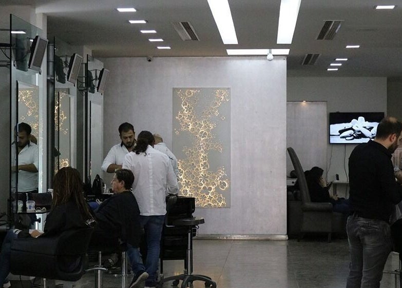 Modern interior of Salon Joseph Haber in North Governorate, LB showcasing hairstylists at work.