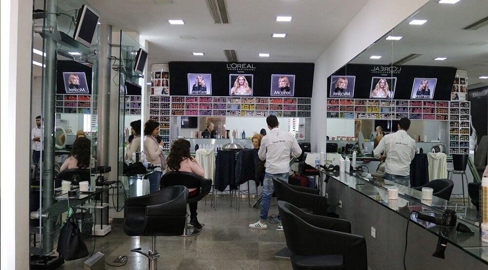 Vibrant interior of Salon Joseph Haber in North Governorate, LB, showcasing hair styling stations and colorful hair products.
