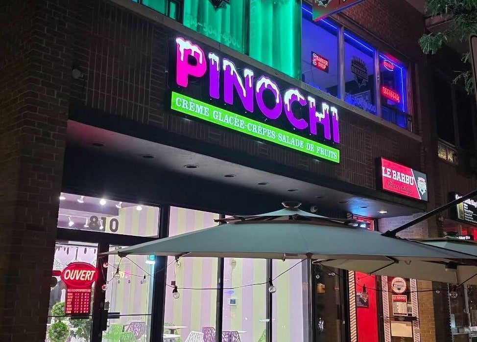 Colorful shopfront near Els The Hairstylist, Montréal, Québec, CA, glowing signs at night.