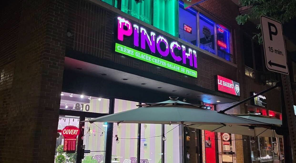Colorful shopfront near Els The Hairstylist, Montréal, Québec, CA, glowing signs at night.