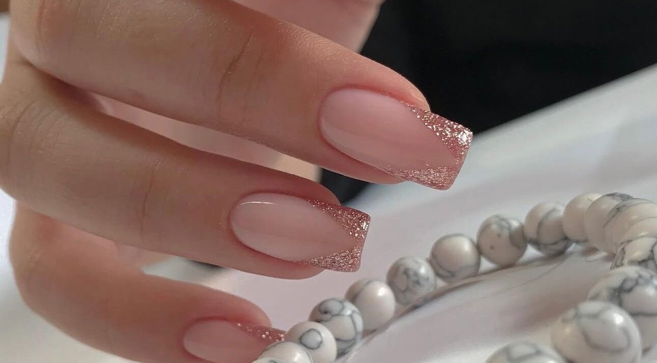 Sparkling pink glitter nails from Amour Nails Midtown in New York, New York, US. Elegant nail artistry.