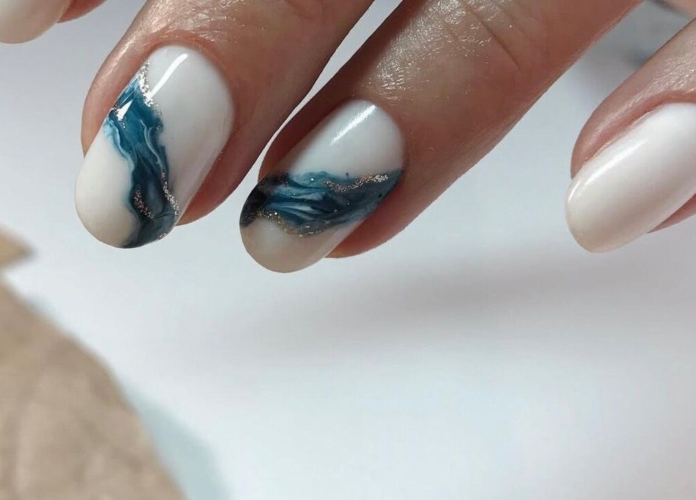 Stylish blue and white nail art at Amour Nails Midtown, New York, New York, US.