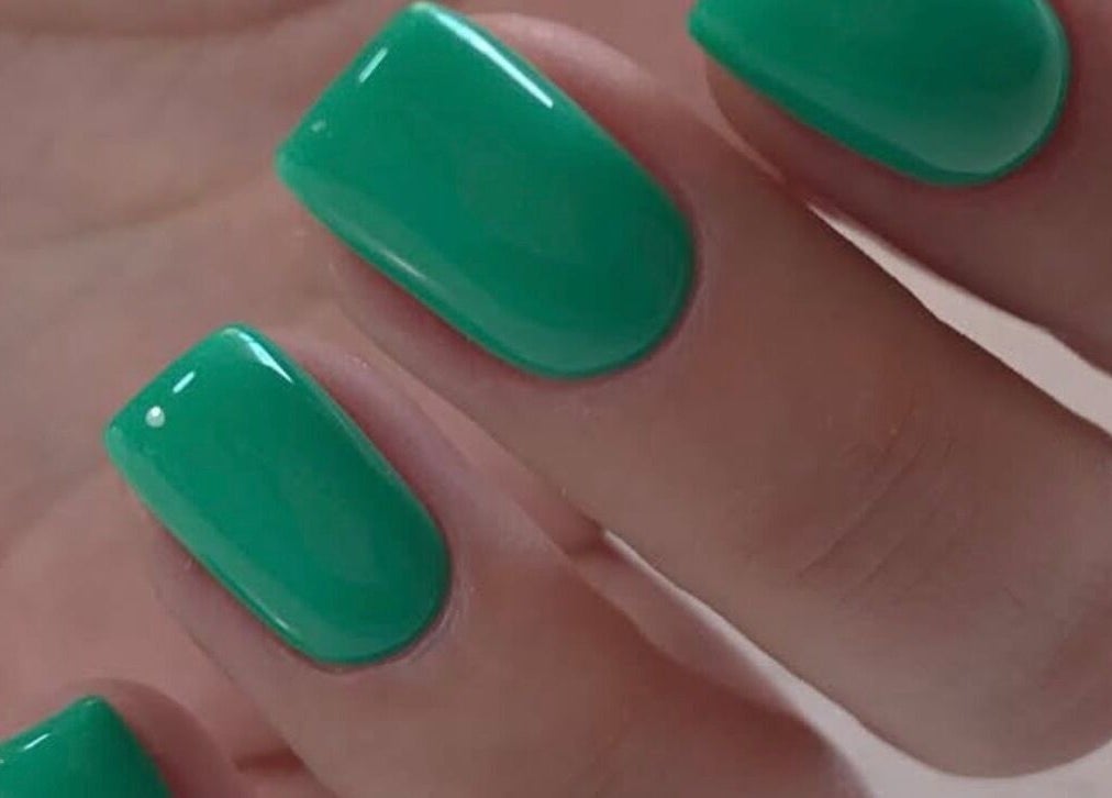 Close-up of vibrant green nails at Amour Nails Midtown, New York, New York, US.