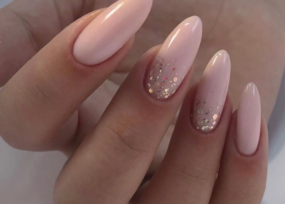 Elegant sparkling manicure at Amour Nails Midtown, New York, New York, US, showcasing glossy nude nails.