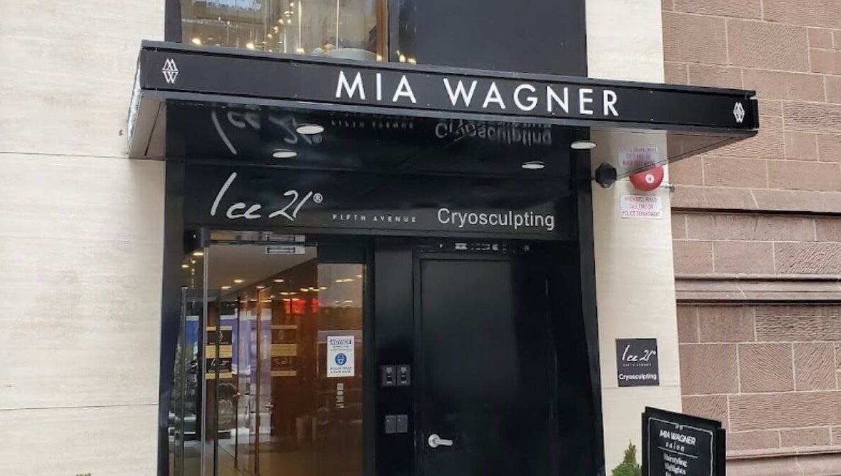 Elegant entrance to Amour Nails Midtown, New York, New York, US. Glass doors beneath black awning.