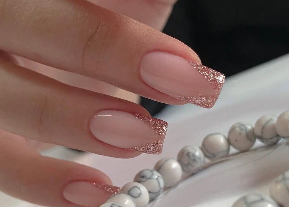 Elegant nude and glitter nails at Amour Nails Midtown, New York, New York, US.