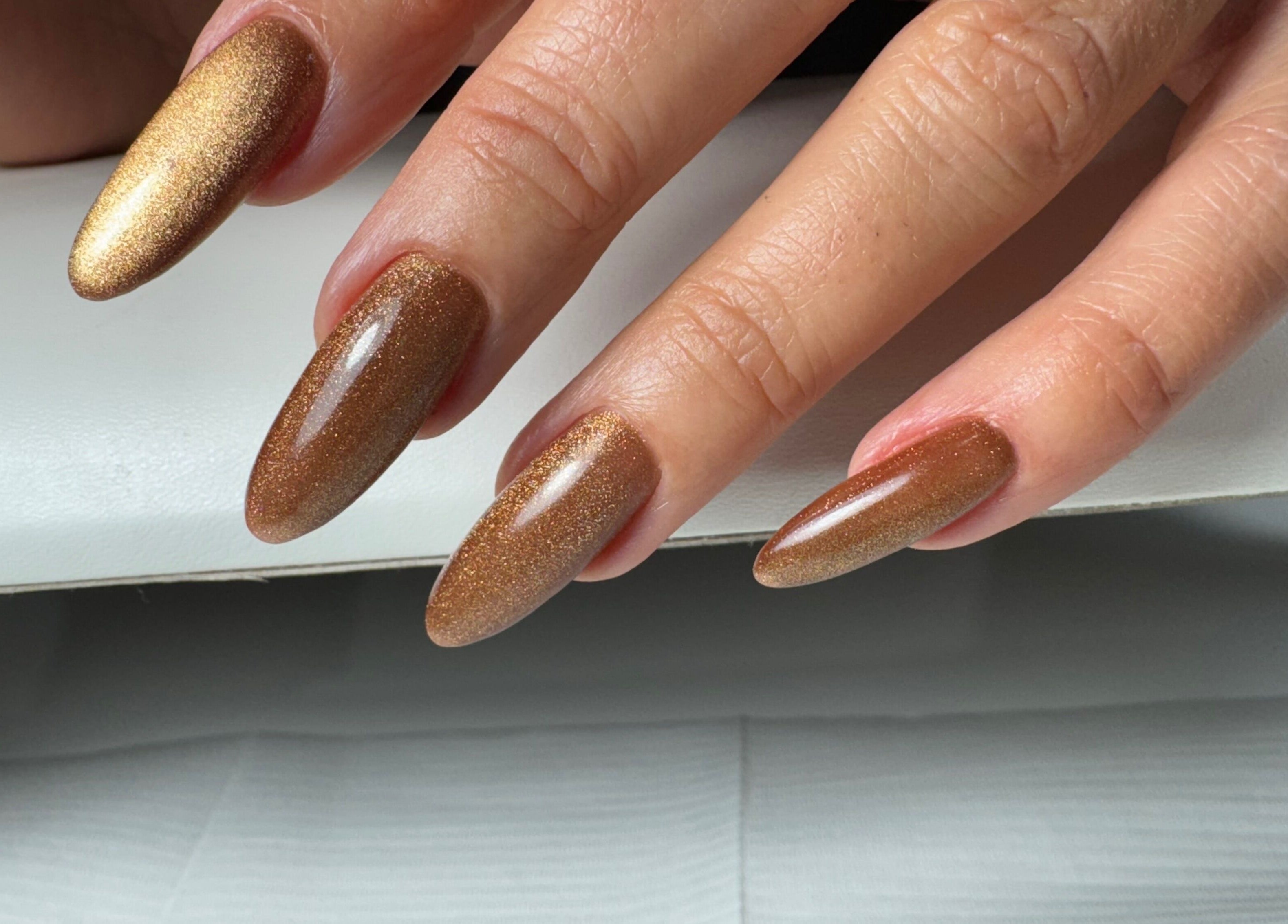 Elegant brown glitter nails at Amour Nails Midtown, New York, New York, US.
