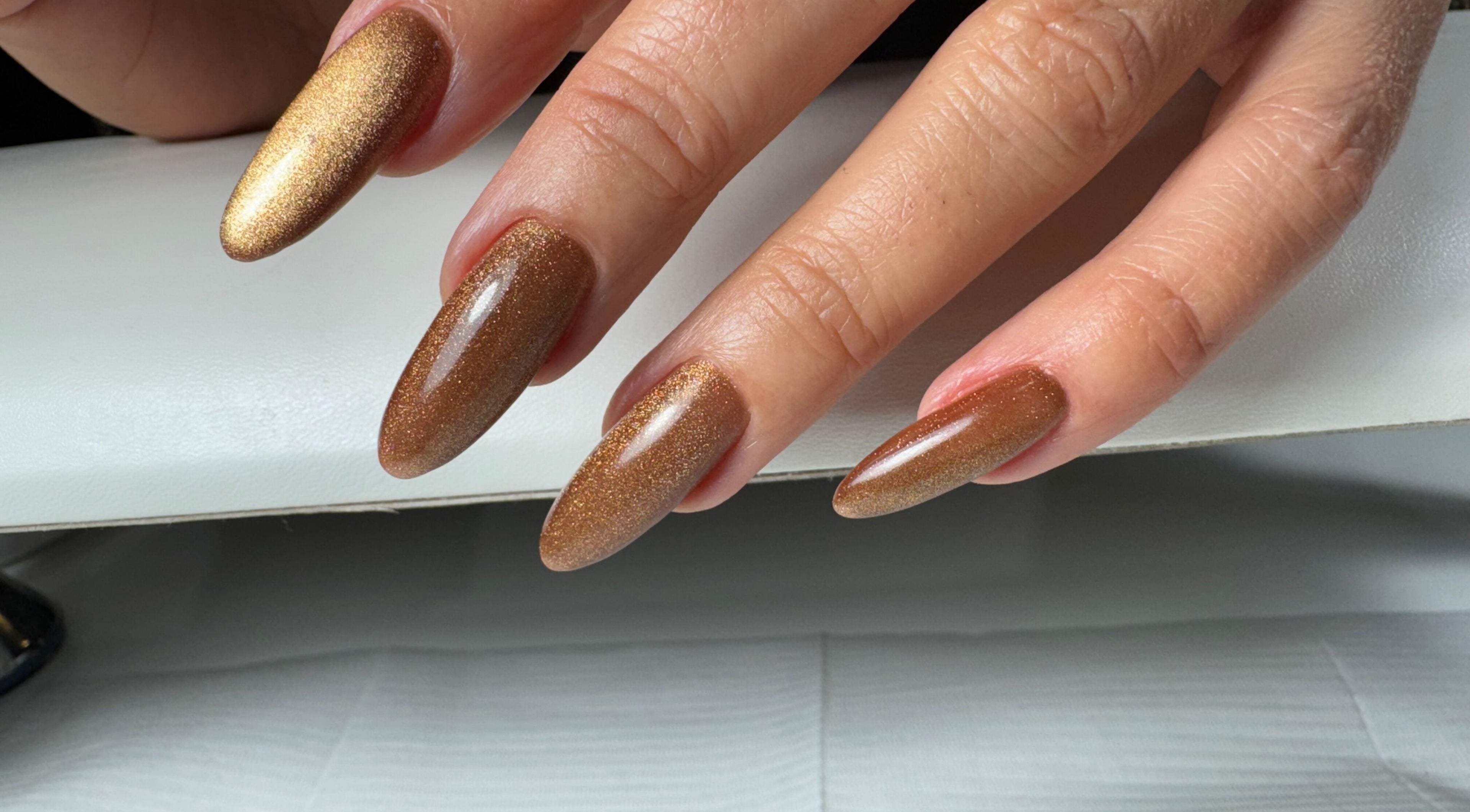 Elegant brown glitter nails at Amour Nails Midtown, New York, New York, US.