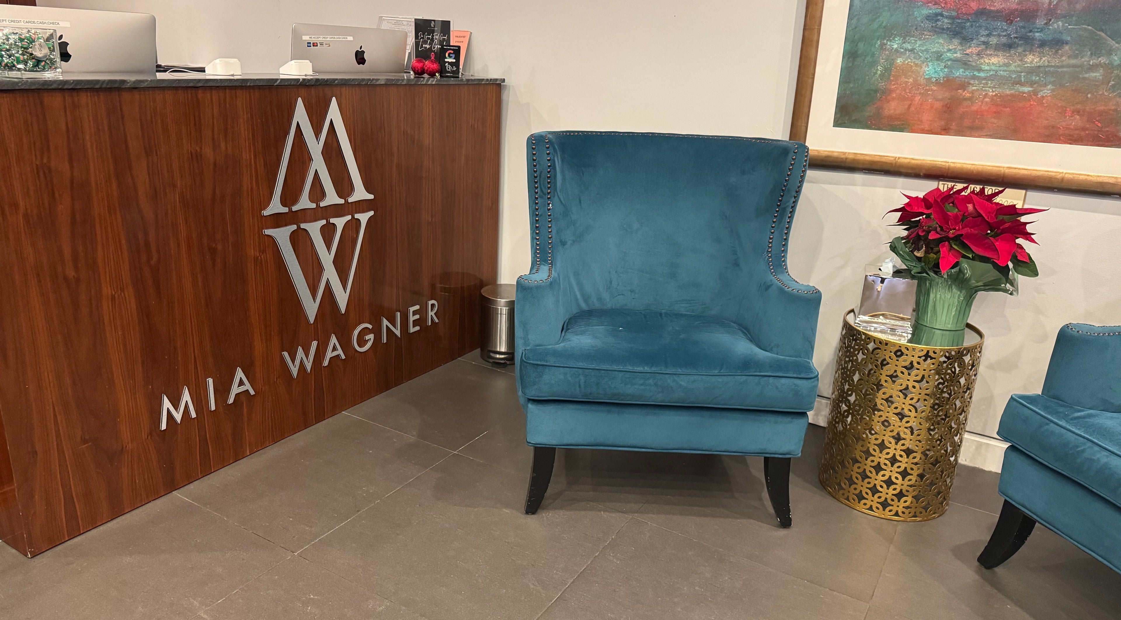 Stylish reception at Amour Nails Midtown in New York, New York, US with plush blue chairs and decor.