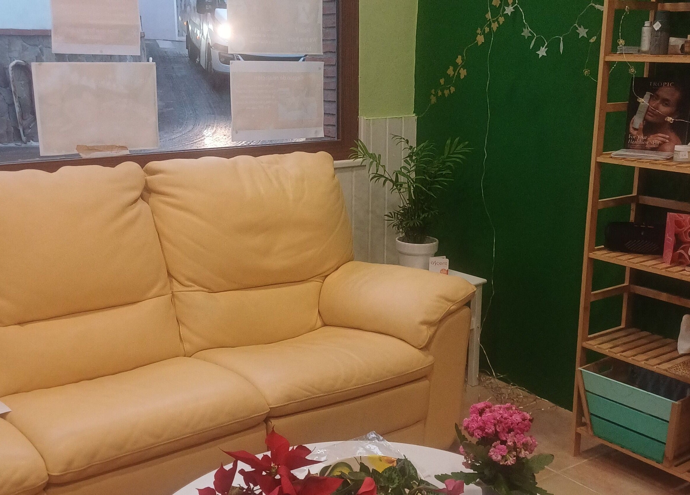 Cozy seating area at ASCENT-THERAPIES AT ALORA in MALAGA, ANDULUCIA, ES featuring a yellow sofa and floral decor.