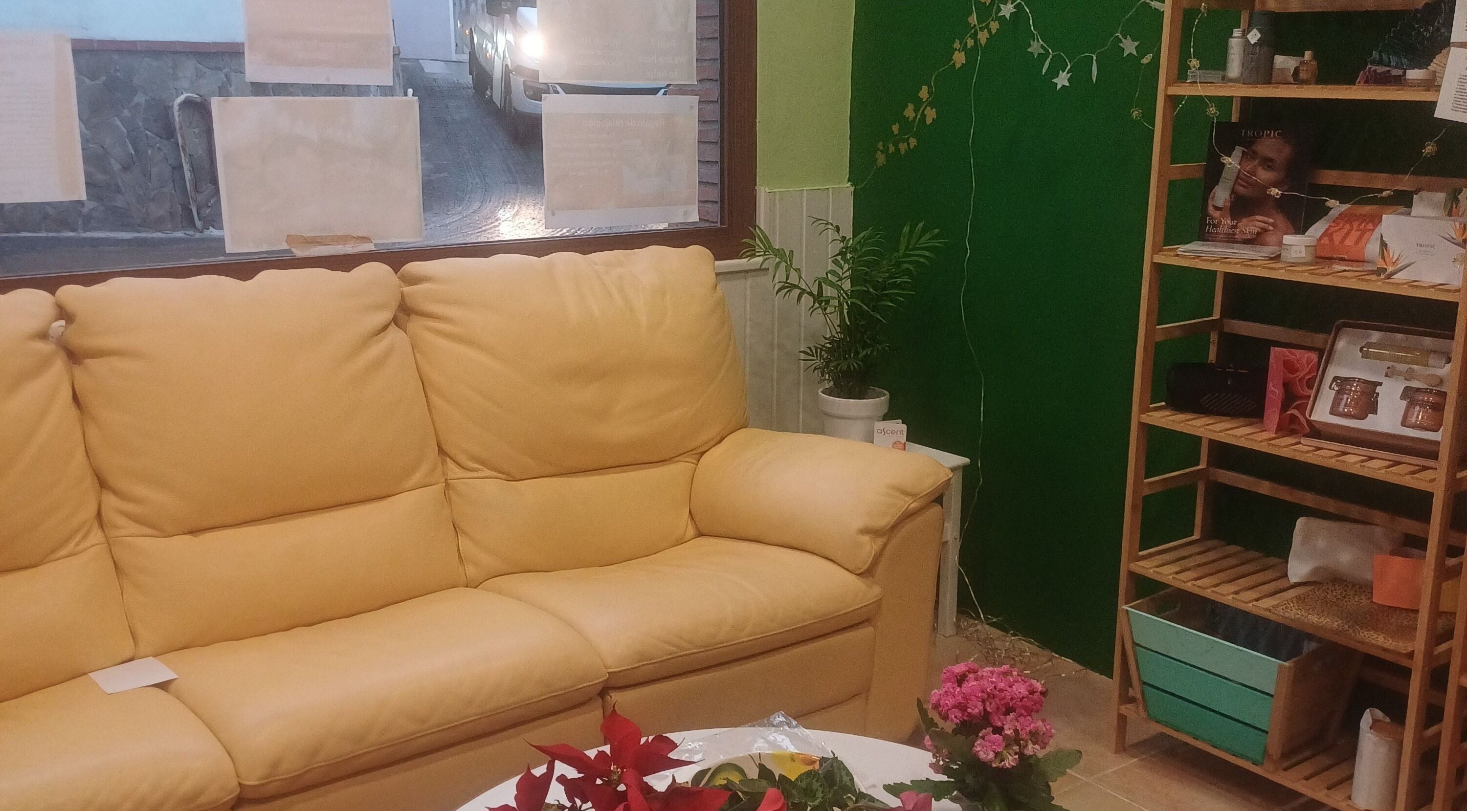 Cozy seating area at ASCENT-THERAPIES AT ALORA in MALAGA, ANDULUCIA, ES featuring a yellow sofa and floral decor.