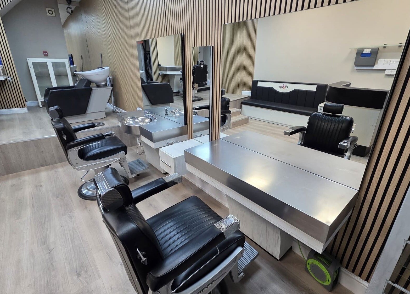 Modern salon interior at Studio Cotham, Bristol, England featuring sleek chairs and mirrors.
