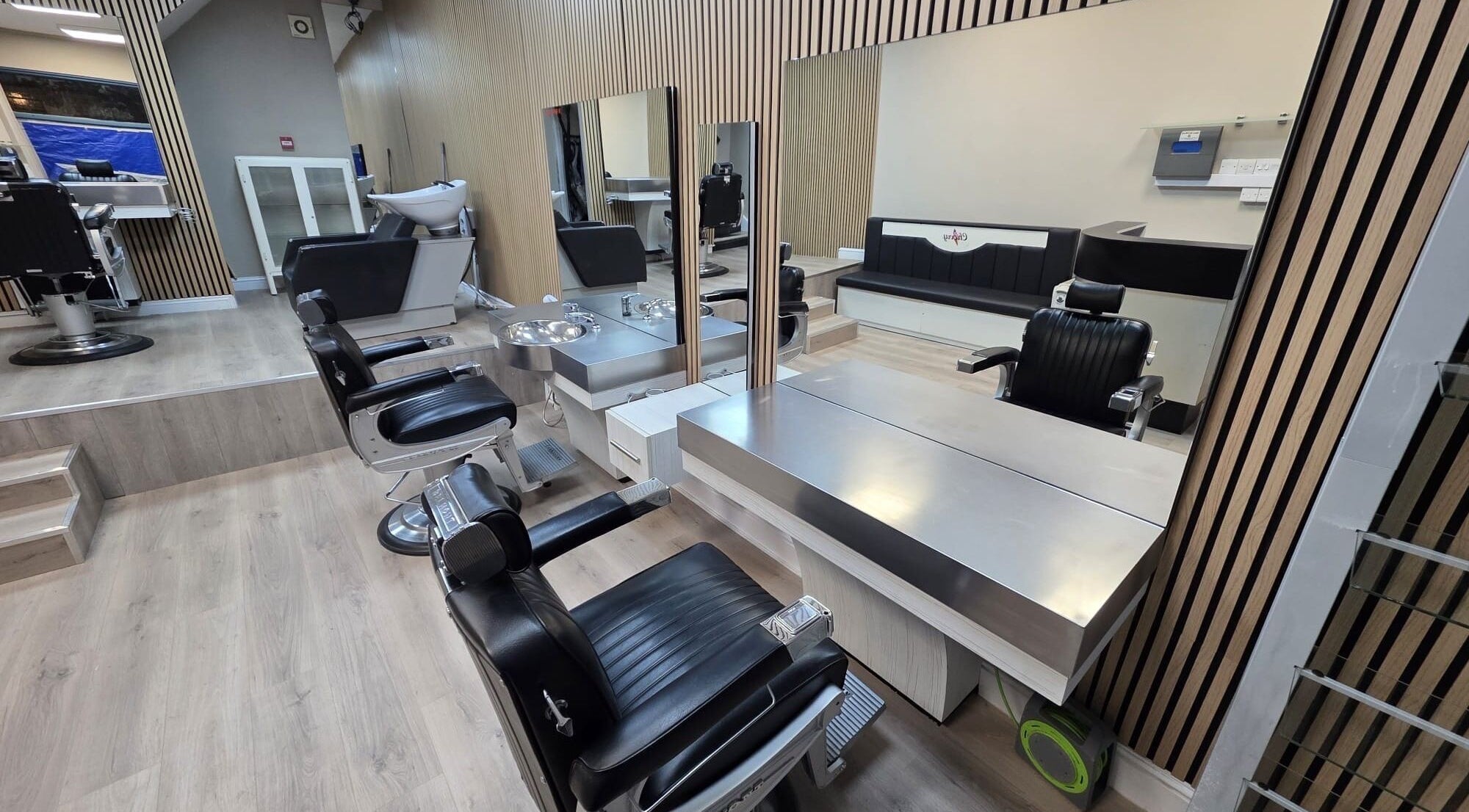 Modern salon interior at Studio Cotham, Bristol, England featuring sleek chairs and mirrors.