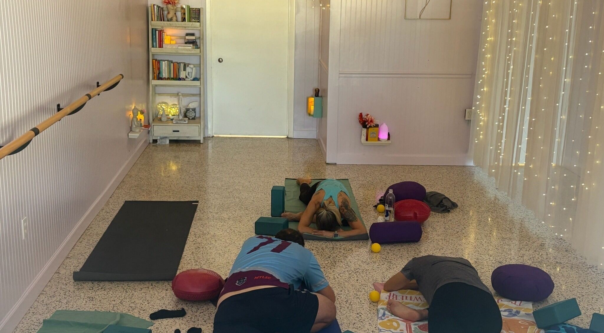 Guests practicing yoga in a tranquil room at SoulVival Wellness, Merritt Island, Florida, US.