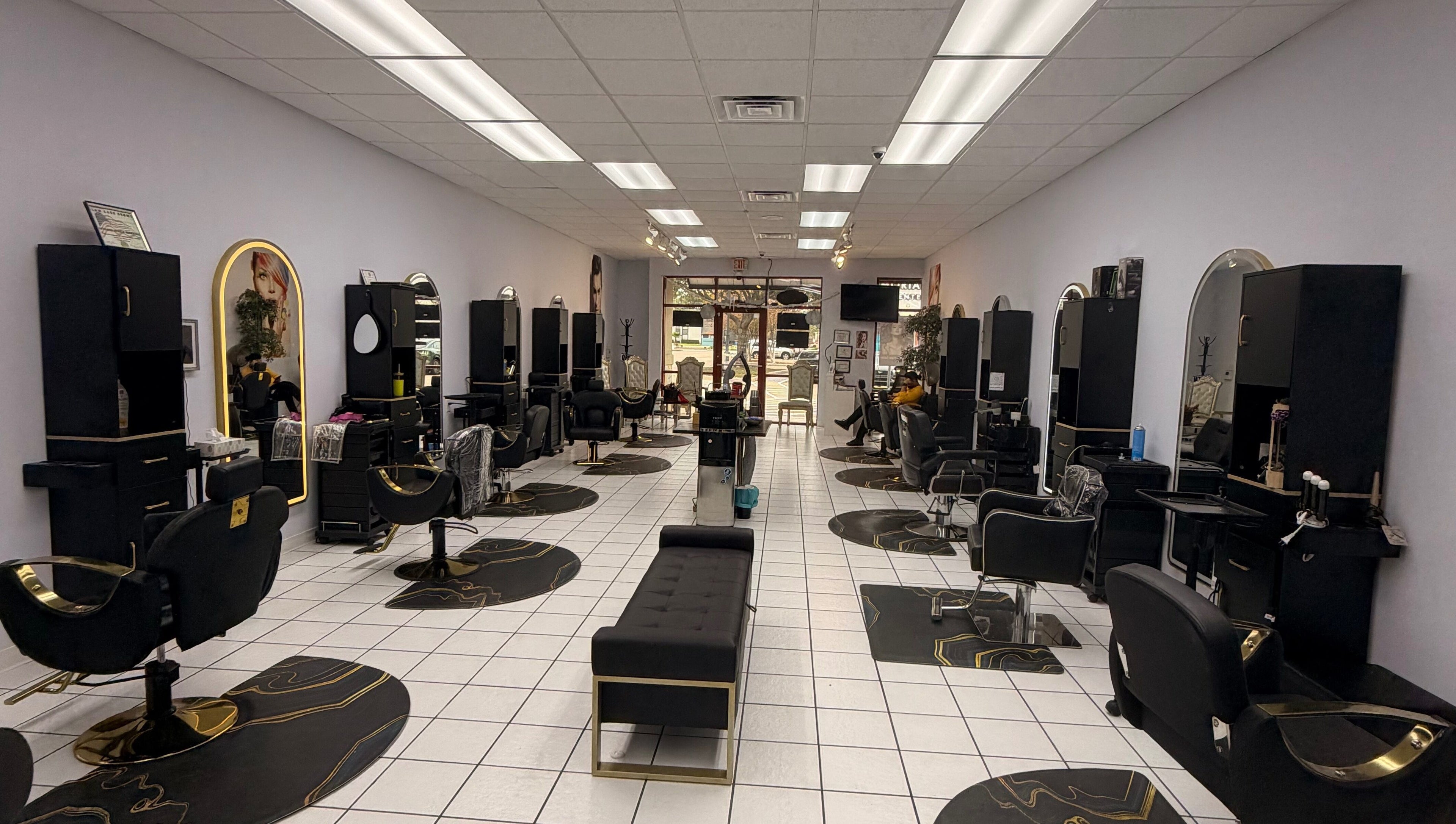 Elegant interior of Jasmine’s beauty salon in Houston, Texas, US showcasing stylish black and gold salon chairs.