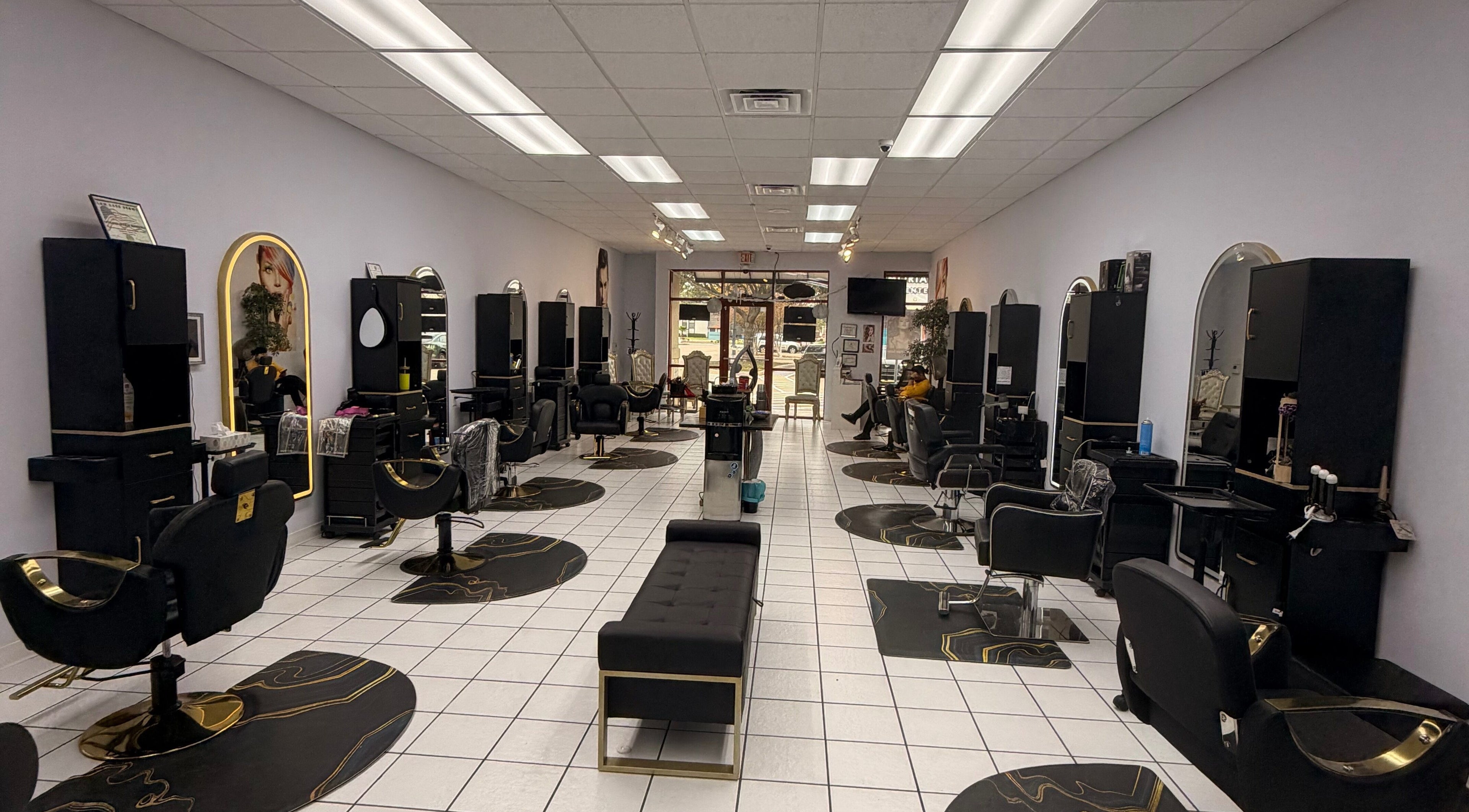 Elegant interior of Jasmine’s beauty salon in Houston, Texas, US showcasing stylish black and gold salon chairs.