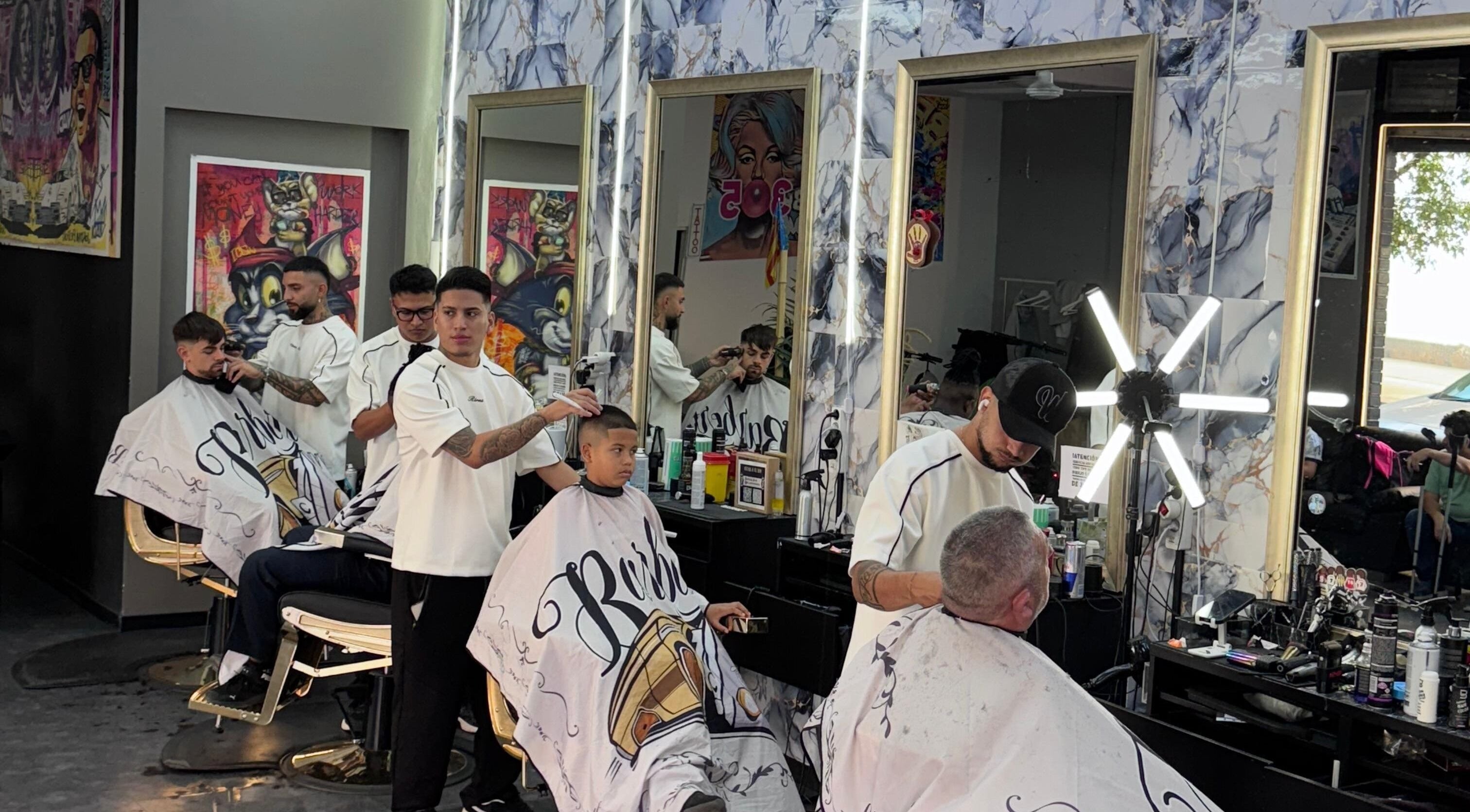 Interior concurrido de 305 Barberia en València, Comunidad Valenciana, ES, mostrando cortes de cabello profesional.
