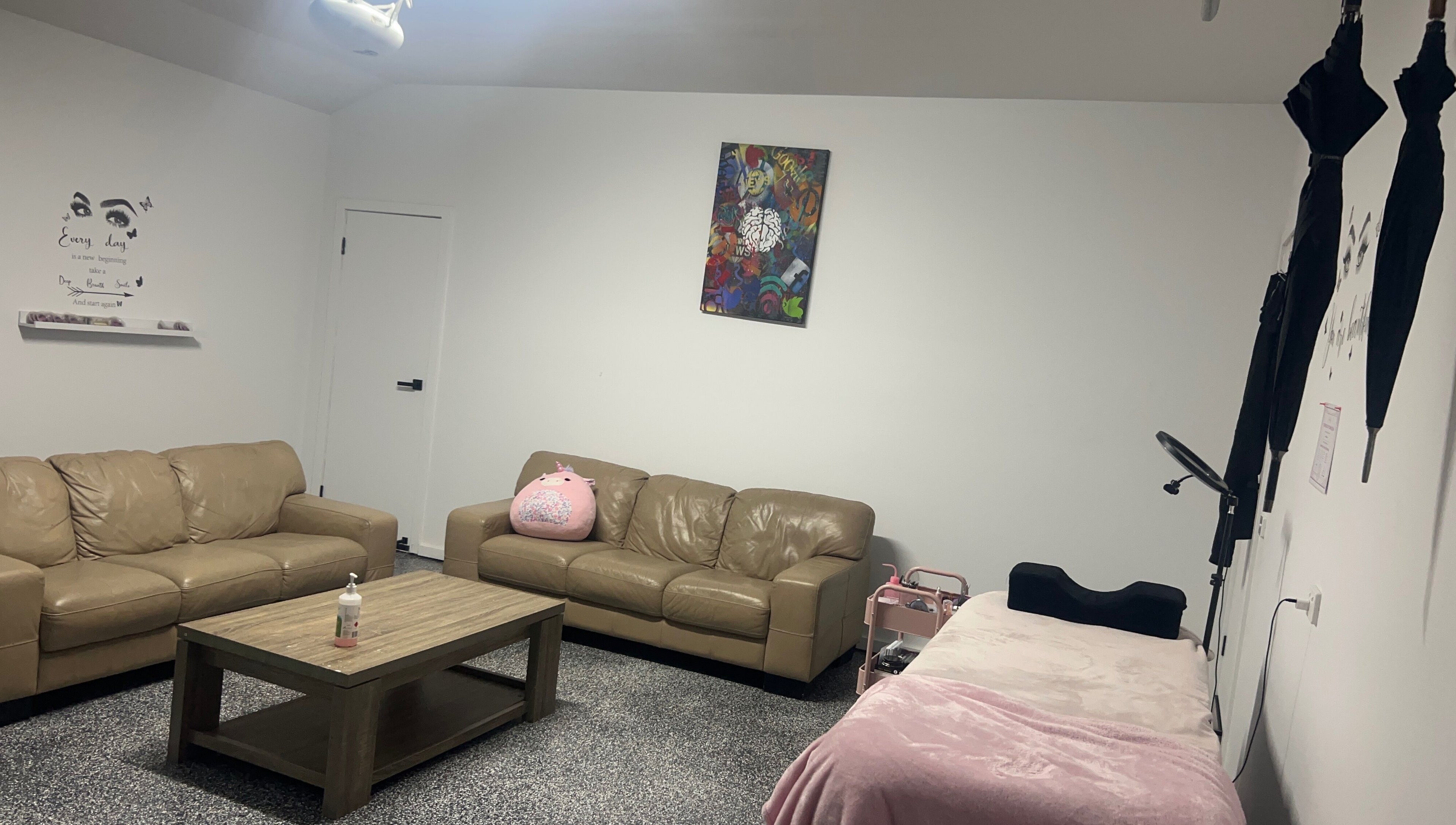 Relaxing lounge at Sultan Lashes, Melbourne, Victoria, AU with comfy sofas and chic decor.