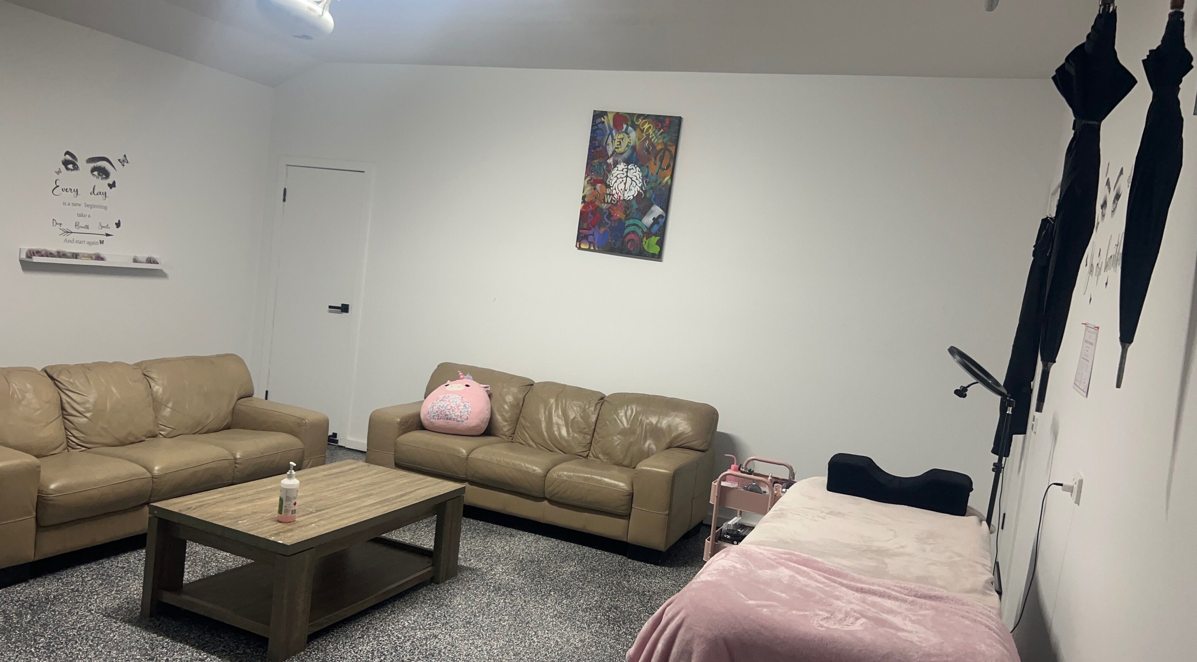 Relaxing lounge at Sultan Lashes, Melbourne, Victoria, AU with comfy sofas and chic decor.