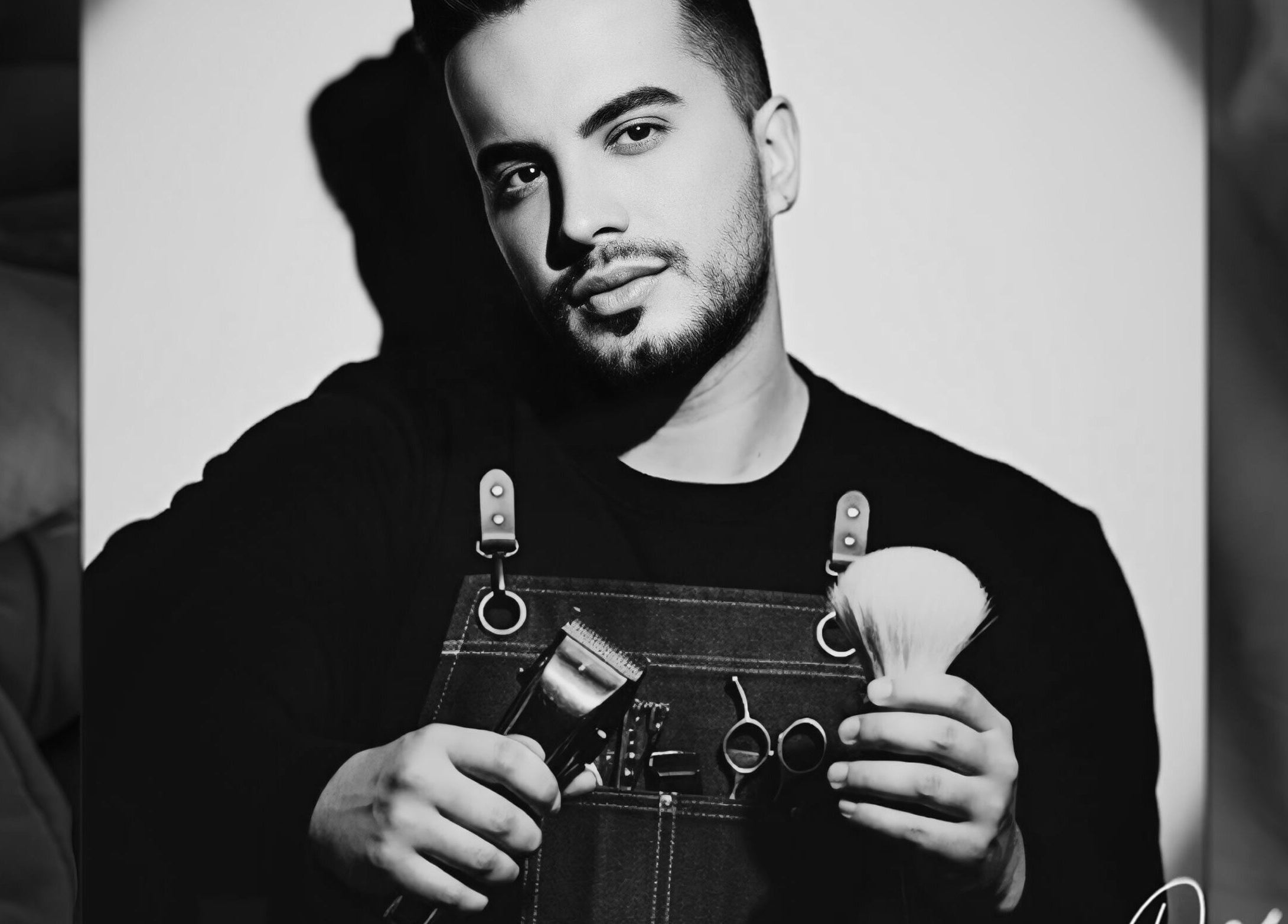 Barber at De Biasio Hair holding tools in Church, England, GB.
